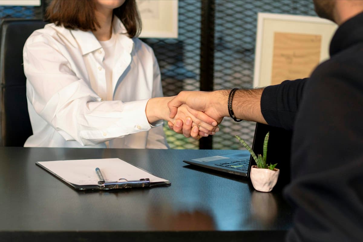 A candidate shaking hands after a successful interview